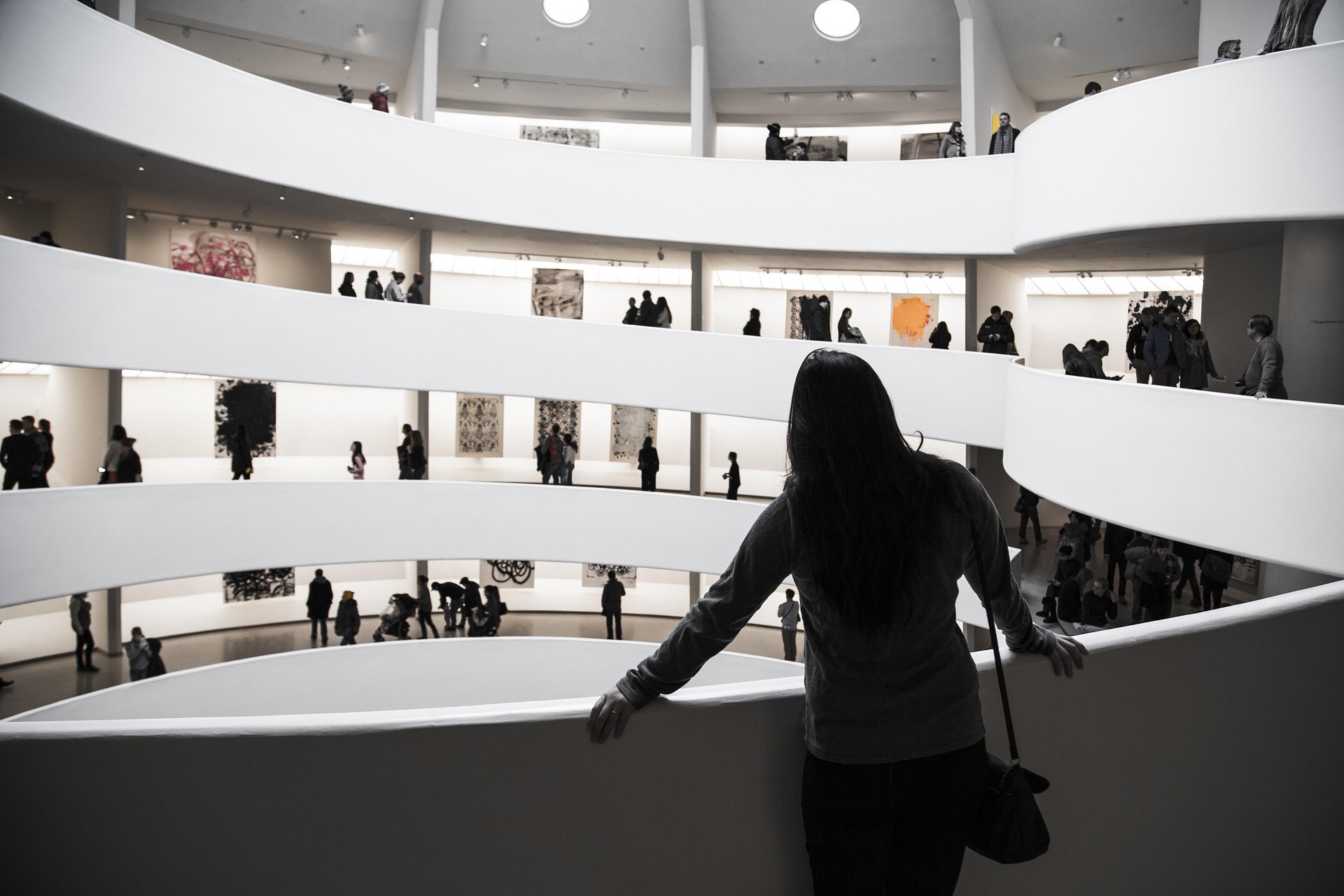 Guests exploring a bright multi-level art museum