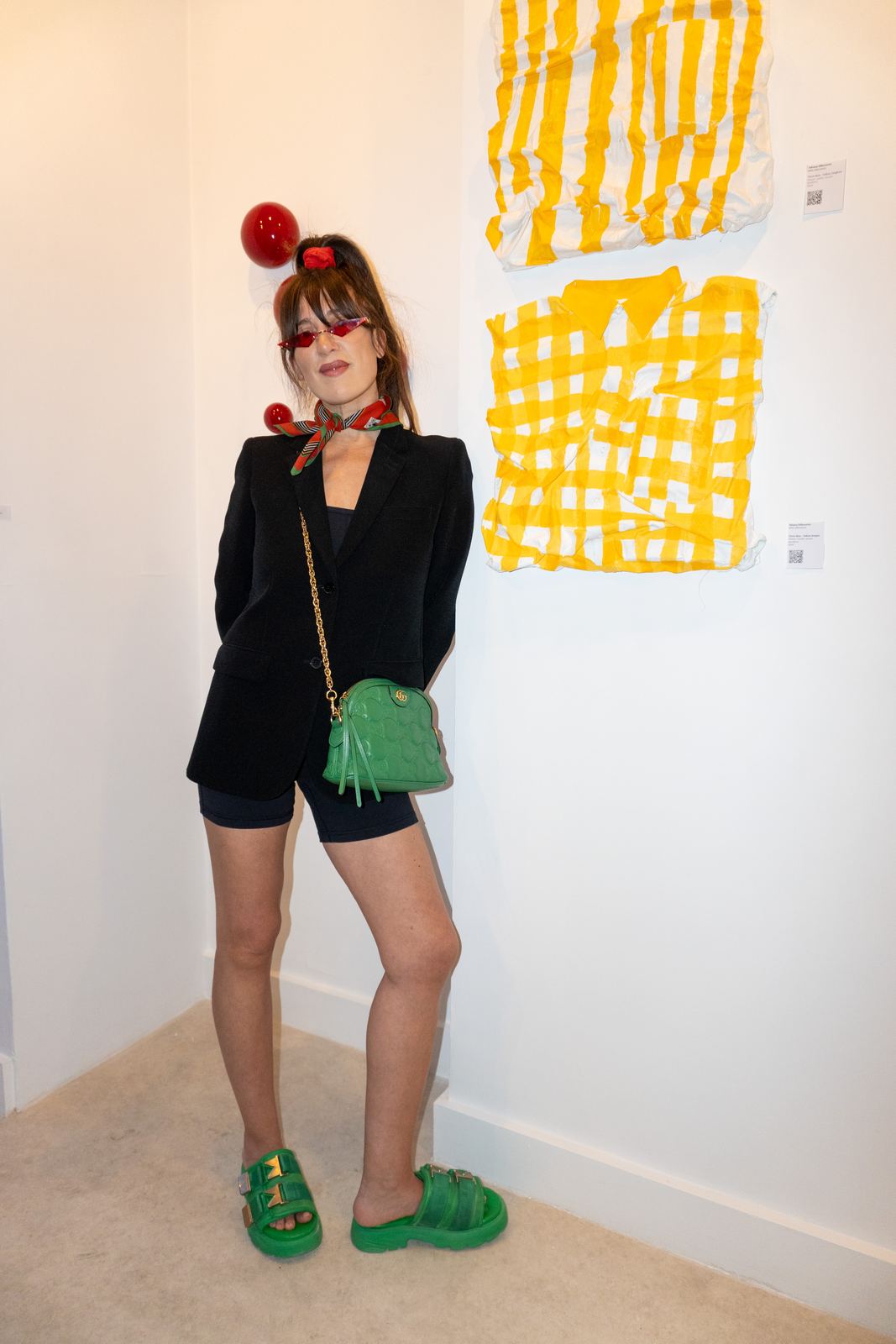 A stylish guest beside yellow artwork