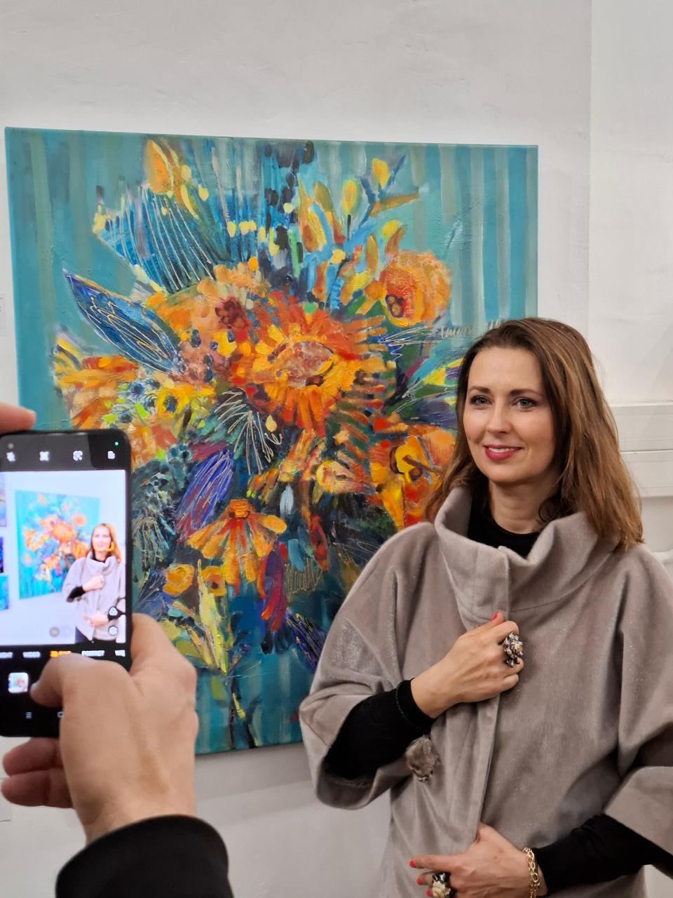A guest being photographed beside art